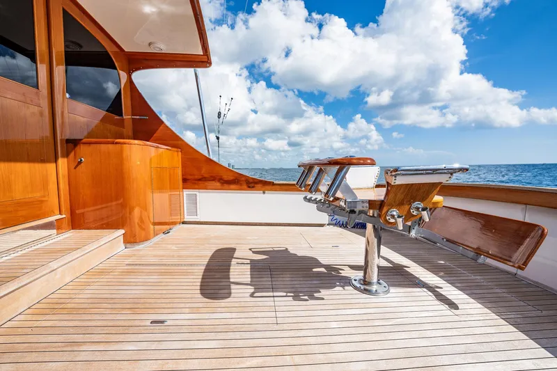 Lucky Yacht Photos Pics 1983 Rybovich 55 Convertible yacht deck with wooden finish, ocean view, and clear sky.