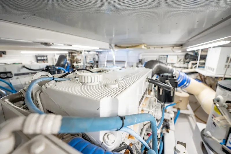 Lucky Yacht Photos Pics Engine room of 1983 Rybovich 55 Convertible yacht with visible machinery and pipes.