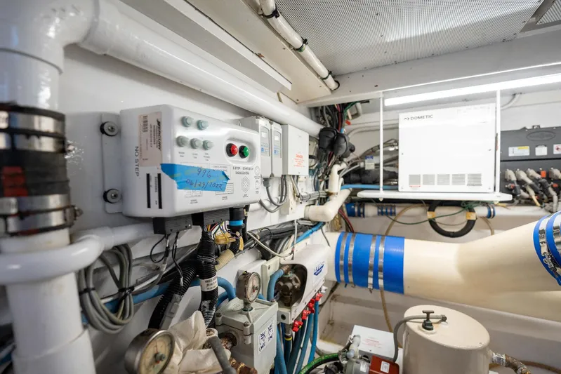 Lucky Yacht Photos Pics Engine room of 1983 Rybovich 55 Convertible yacht with control panels and piping.