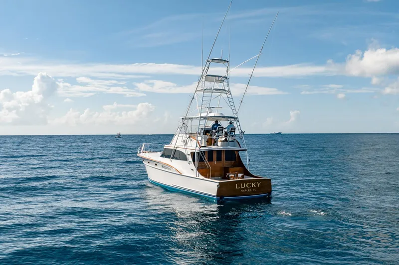 Lucky Yacht Photos Pics 1983 Rybovich 55 Convertible yacht "Lucky" cruising on open ocean under clear skies.