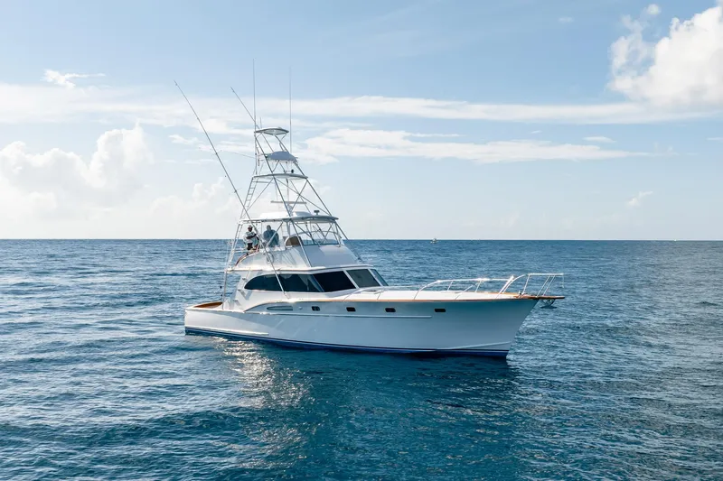 Lucky Yacht Photos Pics 1983 Rybovich 55 Convertible yacht cruising on open sea under clear sky.