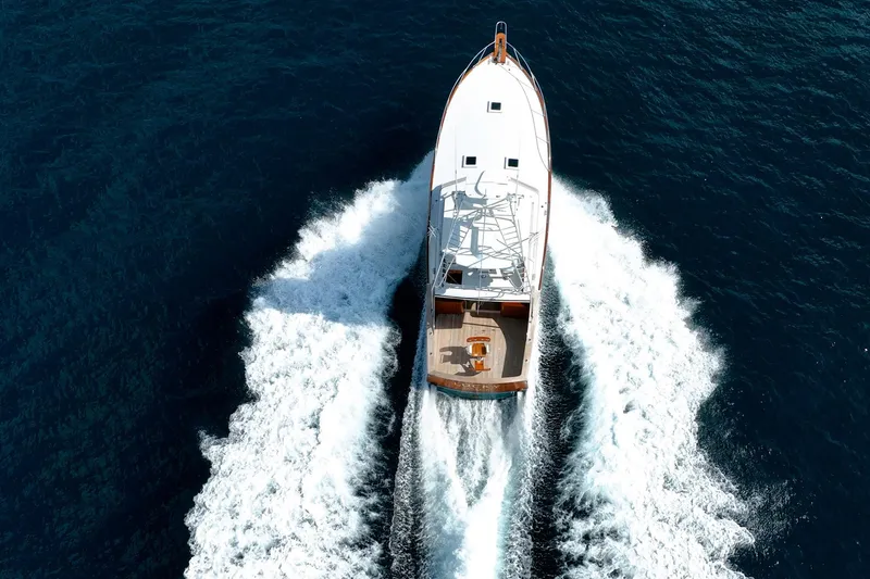 Lucky Yacht Photos Pics Aerial view of 1983 Rybovich 55 Convertible yacht cruising on open water.