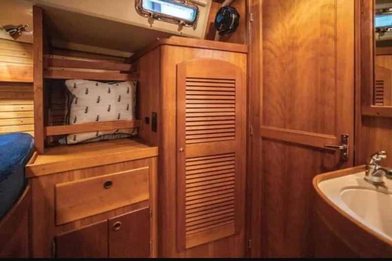 Blue Sky Yacht Photos Pics Interior of 2000 Sabre 402 yacht with wooden cabinetry and cozy sleeping area.