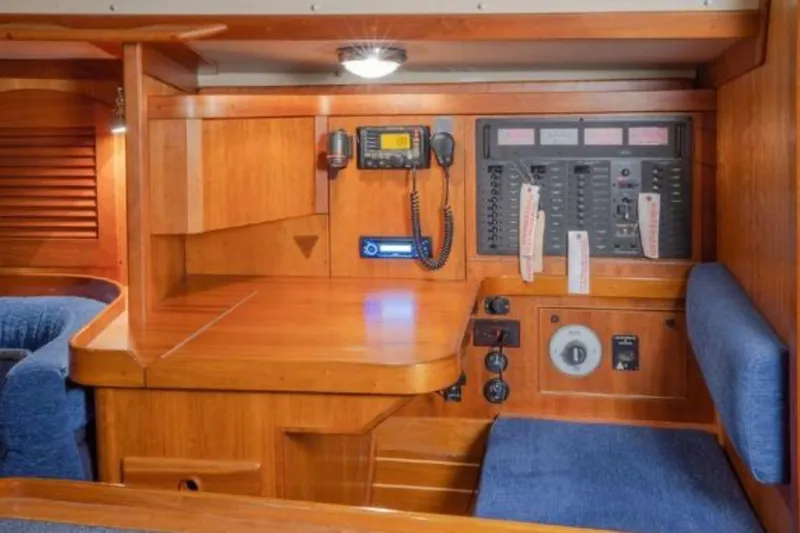 Blue Sky Yacht Photos Pics Navigation station with control panel in 2000 Sabre 402 sailboat interior.