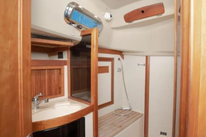 Blue Sky Yacht Photos Pics Interior of 2000 Sabre 402 yacht bathroom with wooden accents and modern fixtures.
