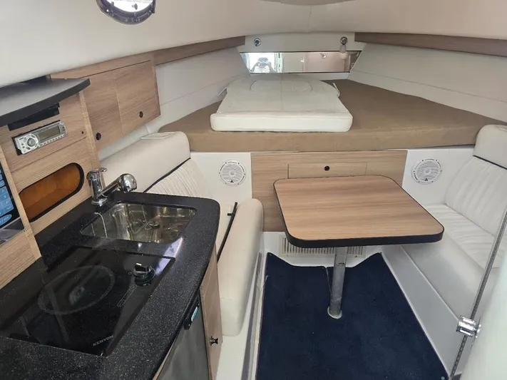  Yacht Photos Pics Interior of 2008 Donzi 38 ZSF boat with kitchenette, seating, and bed.