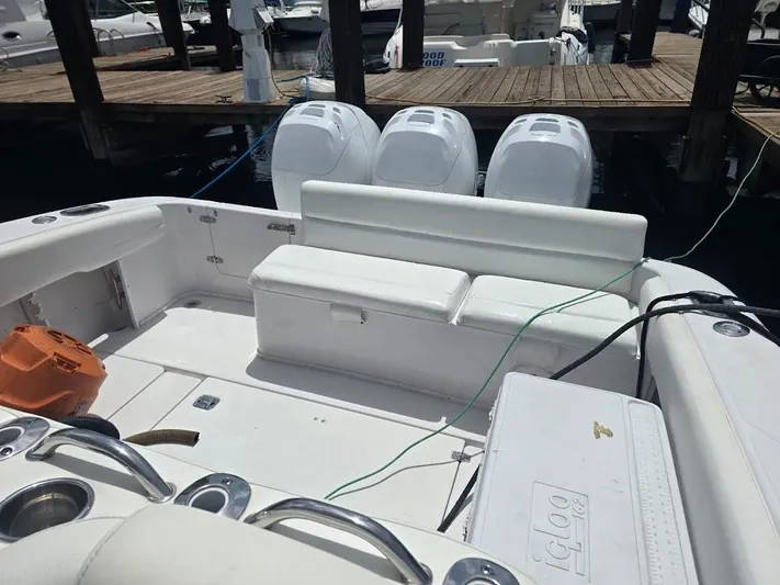  Yacht Photos Pics 2008 Donzi 38 ZSF boat interior with seating and triple outboard engines at dock.