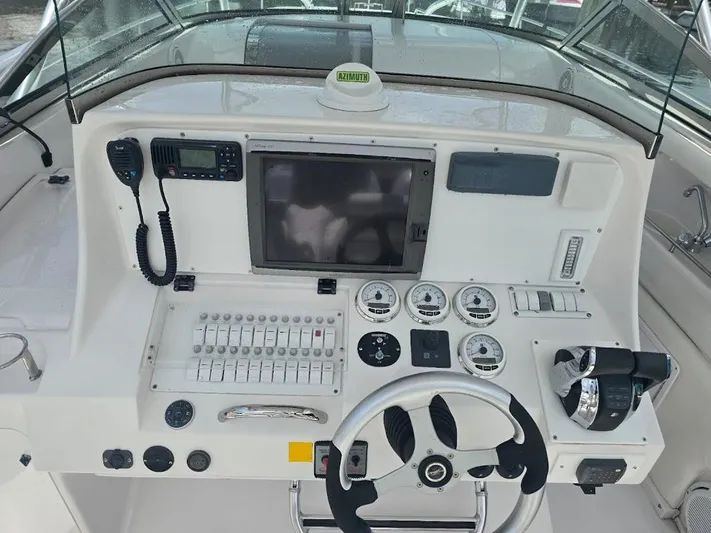  Yacht Photos Pics Control panel of a 2008 Donzi 38 ZSF boat with steering wheel and gauges.