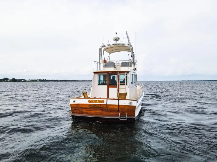 Mystic Yacht Photos Pics 1989 Grand Banks 36 Sedan boat on open water, rear view.
