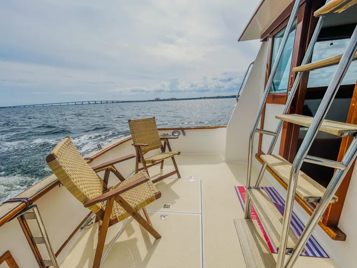 Mystic Yacht Photos Pics 1989 Grand Banks 36 Sedan deck with chairs, ocean view, and ladder.
