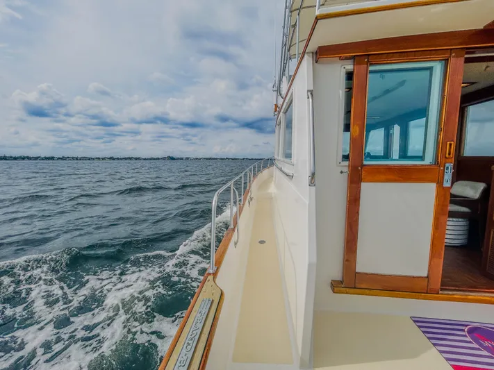 Mystic Yacht Photos Pics 1989 Grand Banks 36 Sedan cruising on open water under a cloudy sky.