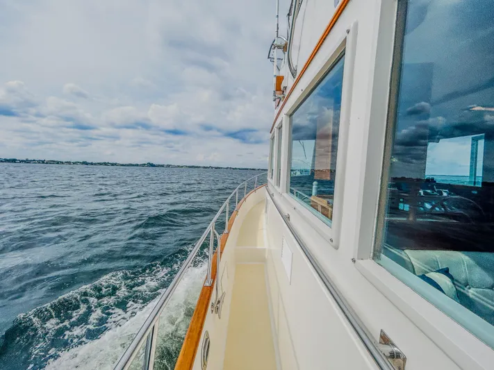 Mystic Yacht Photos Pics 1989 Grand Banks 36 Sedan cruising on open water under a cloudy sky.