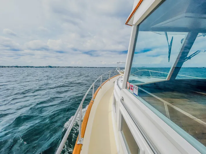Mystic Yacht Photos Pics 1989 Grand Banks 36 Sedan cruising on open water under cloudy skies.