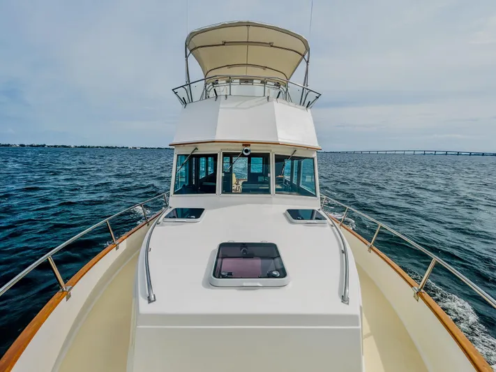 Mystic Yacht Photos Pics 1989 Grand Banks 36 Sedan cruising on open water, showcasing classic design and spacious deck.
