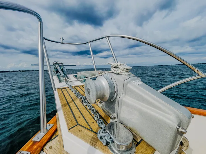 Mystic Yacht Photos Pics 1989 Grand Banks 36 Sedan yacht bow with anchor chain, on open water under cloudy sky.