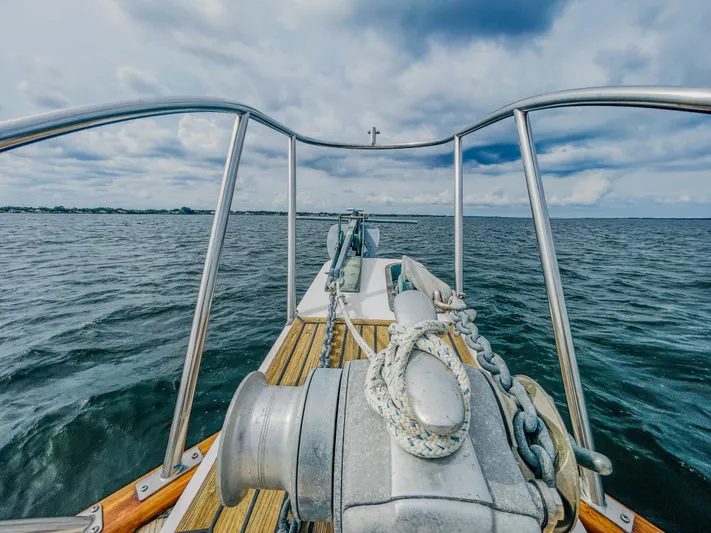 Mystic Yacht Photos Pics Bow view of 1989 Grand Banks 36 Sedan on open water under cloudy skies.