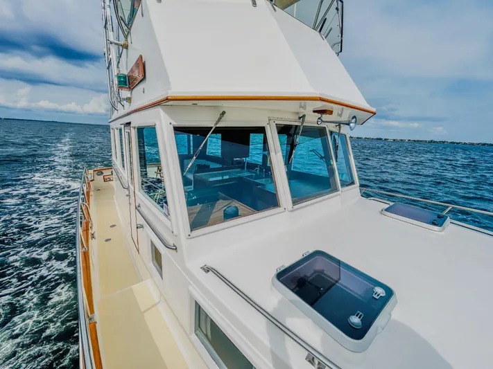 Mystic Yacht Photos Pics 1989 Grand Banks 36 Sedan cruising on open water under a clear sky.