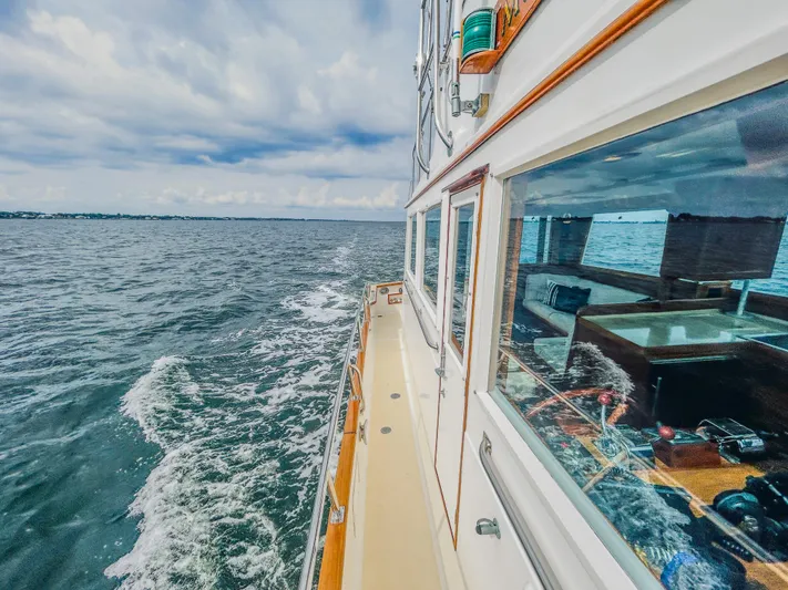 Mystic Yacht Photos Pics 1989 Grand Banks 36 Sedan cruising on open water, showcasing classic design and craftsmanship.