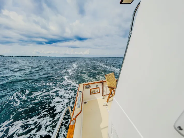 Mystic Yacht Photos Pics 1989 Grand Banks 36 Sedan cruising on open water under a cloudy sky.