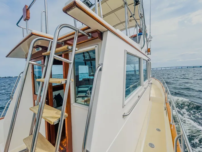 Mystic Yacht Photos Pics 1989 Grand Banks 36 Sedan yacht cruising on open water, showcasing exterior and ladder.