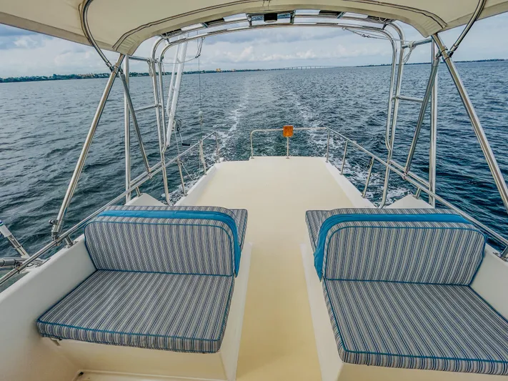 Mystic Yacht Photos Pics 1989 Grand Banks 36 Sedan boat deck with cushioned seating, overlooking open water.