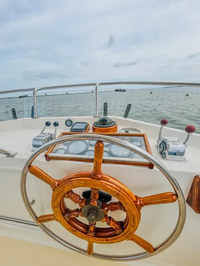 Mystic Yacht Photos Pics 1989 Grand Banks 36 Sedan helm with wooden steering wheel, nautical instruments, and ocean view.