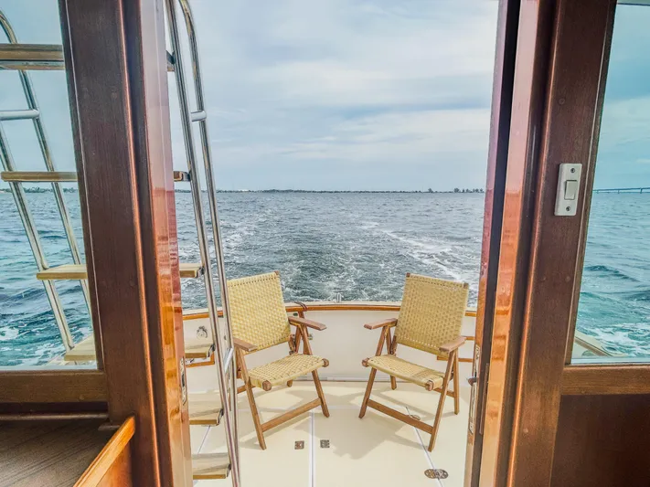 Mystic Yacht Photos Pics 1989 Grand Banks 36 Sedan yacht with chairs on deck, ocean view.