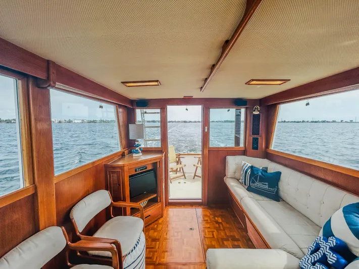 Mystic Yacht Photos Pics Interior of 1989 Grand Banks 36 Sedan yacht with wooden furnishings and water view.