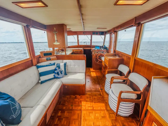 Mystic Yacht Photos Pics Interior of 1989 Grand Banks 36 Sedan with wooden furnishings and ocean view.