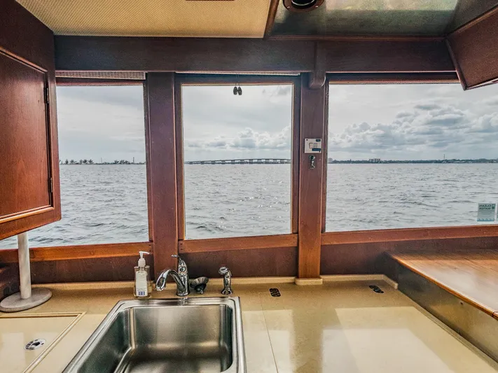 Mystic Yacht Photos Pics Interior view from a 1989 Grand Banks 36 Sedan, showcasing a kitchen sink and ocean scenery.