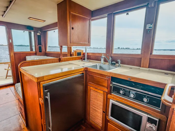 Mystic Yacht Photos Pics Interior of 1989 Grand Banks 36 Sedan yacht with kitchen and ocean view.