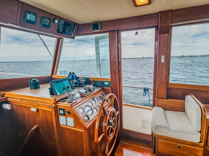 Mystic Yacht Photos Pics 1989 Grand Banks 36 Sedan helm with wooden steering wheel and ocean view.