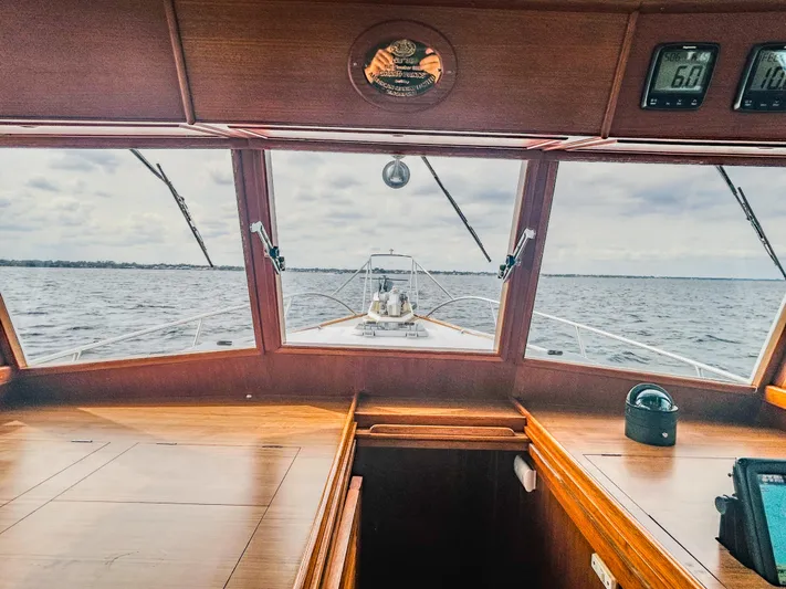 Mystic Yacht Photos Pics 1989 Grand Banks 36 Sedan interior view, showcasing wooden dashboard and ocean horizon.
