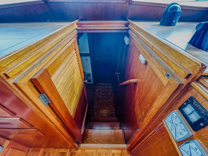 Mystic Yacht Photos Pics Interior view of 1989 Grand Banks 36 Sedan, showcasing wooden stairs and cabinetry.