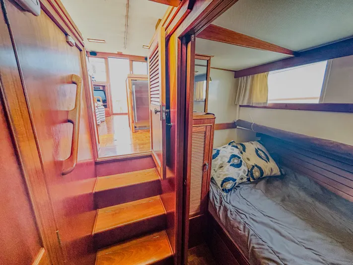 Mystic Yacht Photos Pics 1989 Grand Banks 36 Sedan interior with wooden stairs and cozy cabin bed.