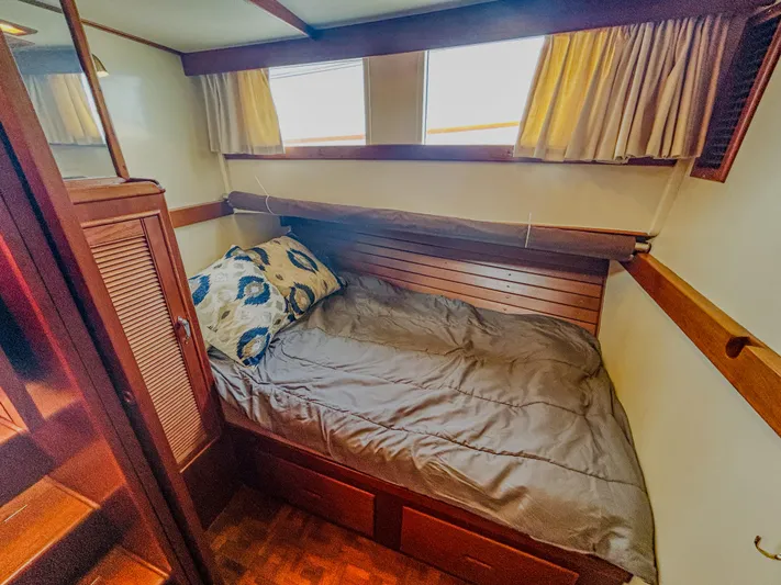 Mystic Yacht Photos Pics Cozy cabin interior of 1989 Grand Banks 36 Sedan with wooden accents and bed.