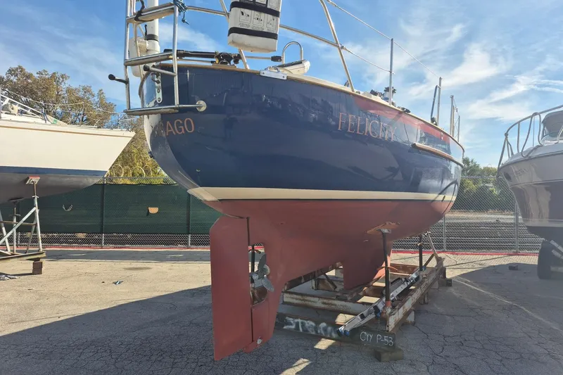 Felicity Yacht Photos Pics 1997 Pacific Seacraft 34 sailboat on dry dock, blue hull, sunny day.