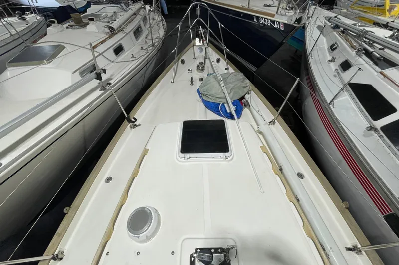 Felicity Yacht Photos Pics 1997 Pacific Seacraft 34 sailboat deck view in marina, surrounded by other boats.