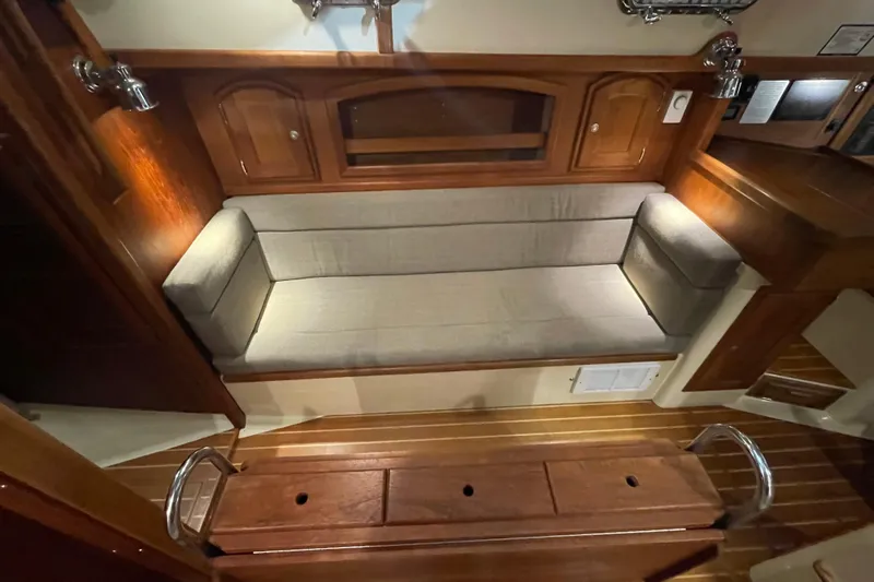 Felicity Yacht Photos Pics Interior of 1997 Pacific Seacraft 34 sailboat with wooden cabinetry and cushioned seating.