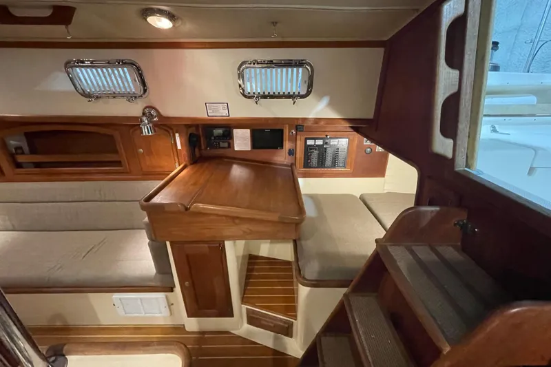 Felicity Yacht Photos Pics Interior of 1997 Pacific Seacraft 34 sailboat with wooden cabinetry and seating area.