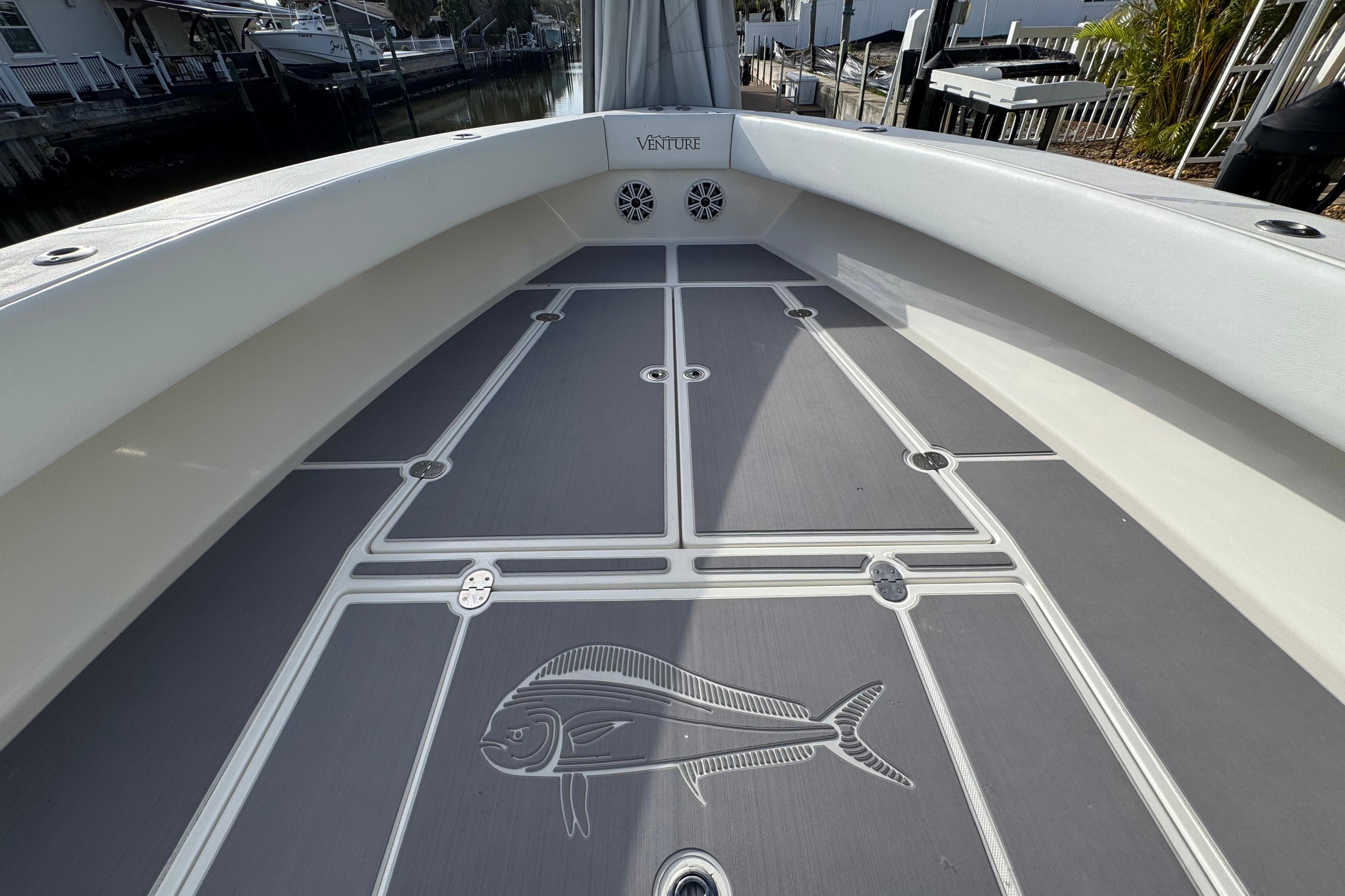 2009 Venture 39 Center Console boat deck with fish design and sleek finish.