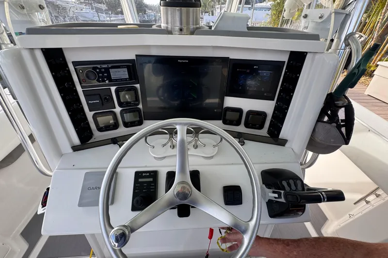  Yacht Photos Pics 2009 Venture 39 Center Console helm with steering wheel and navigation controls.