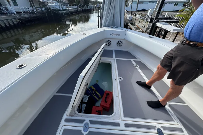  Yacht Photos Pics 2009 Venture 39 Center Console boat with open storage compartment on deck.