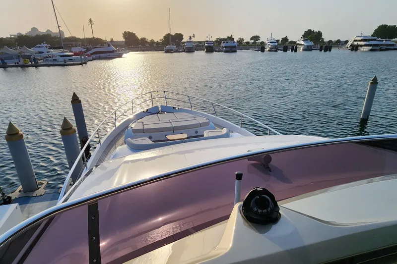  Yacht Photos Pics 2025 Princess Y72 Motor Yacht docked at marina during sunset, with calm waters.