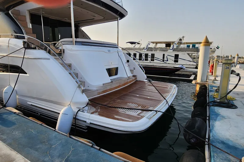  Yacht Photos Pics 2025 Princess Y72 Motor Yacht docked at marina, showcasing sleek design and spacious deck.