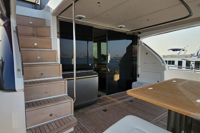  Yacht Photos Pics 2025 Princess Y72 Motor Yacht deck with wooden stairs and glass doors.