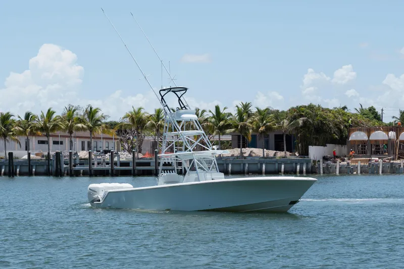  Yacht Photos Pics 2017 SeaVee 390Z boat cruising near palm-lined shore under clear sky.