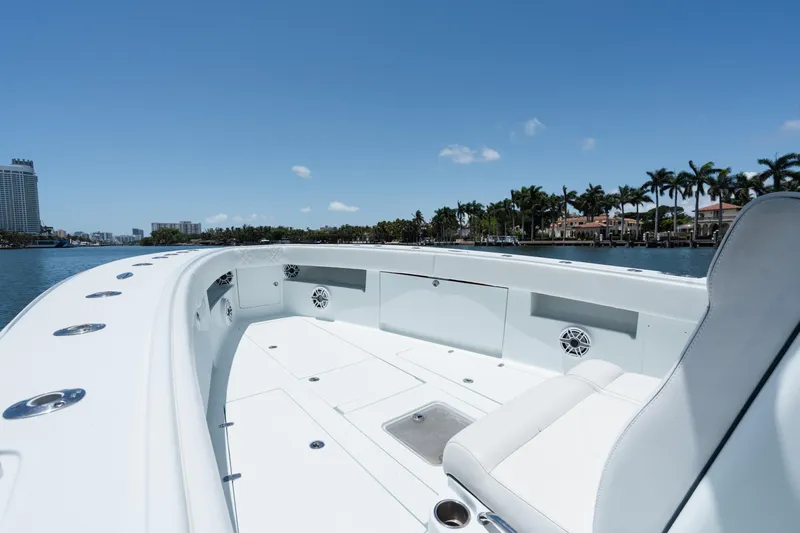 Yacht Photos Pics 2017 SeaVee 390Z boat interior with seating, on a sunny day near waterfront homes.