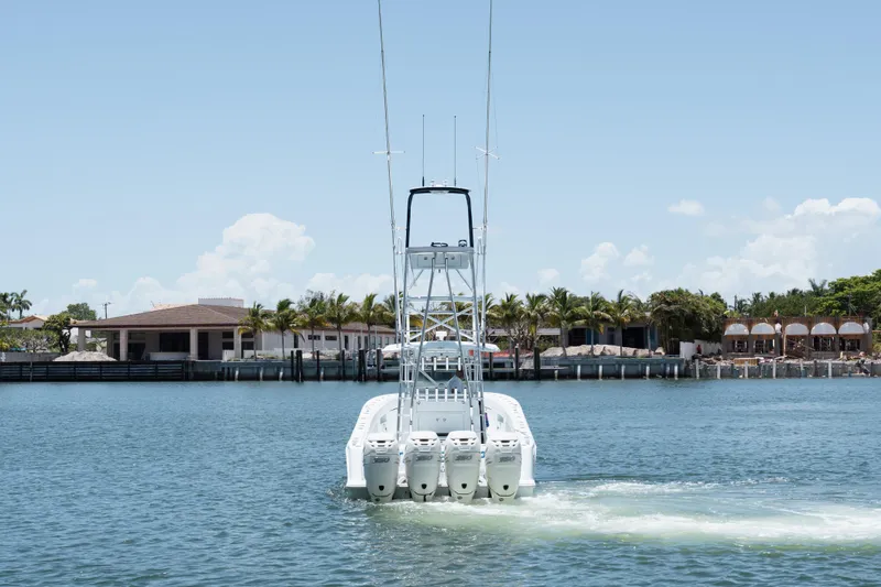  Yacht Photos Pics 2017 SeaVee 390Z boat on water, rear view, with coastal buildings in background.