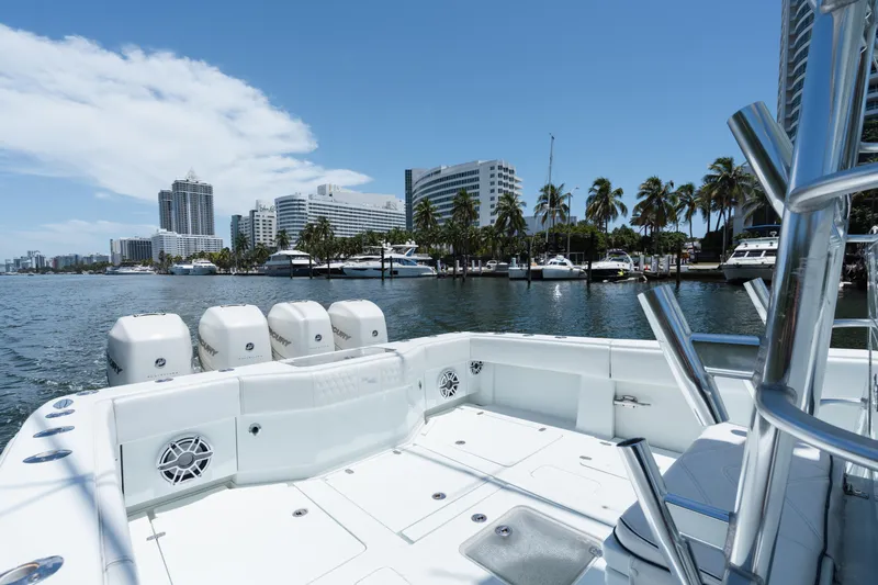  Yacht Photos Pics 2017 SeaVee 390Z boat with four engines, docked near palm trees and city skyline.